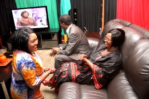 President Lungu watches ZNBC television at the residence of Zambia's High Commissioner to South Africa, Mr. Muyeba Chikonde on 13th June, 2015. With him are First Lady, Esther Lungu and Mrs. Musonda Chikonde