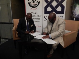 Zambia Association of Chambers of Commerce and Industry vice-president Dr. Chabuka Kawesha and South Africa Chamber of Commerce and Industry representative, Mr. Vuyo Khumalo sign a memorandum of understanding at the launch of the Zambia-South Africa Business Council in Johannesburg on Friday, 30th October, 2015.